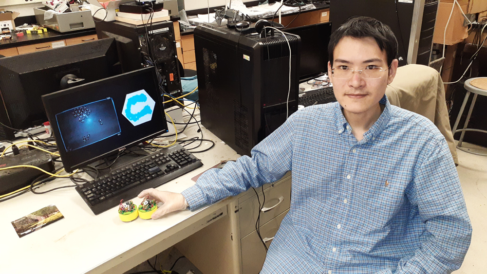 Shengkai Li, a graduate student in physics at Georgia Tech, with two BOBbots (Credit: Shengkai Li)