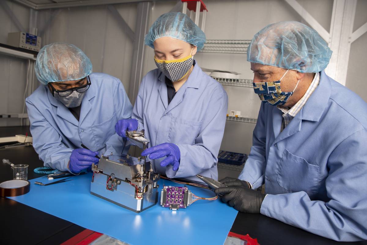 Aerospace Engineering Professor Glenn Lightsey and graduate students Brandon Colón and Lacey Littleton assemble the propulsion system developed at Georgia Tech for the Lunar Flashlight CubeSat. (Credit: Candler Hobbs)