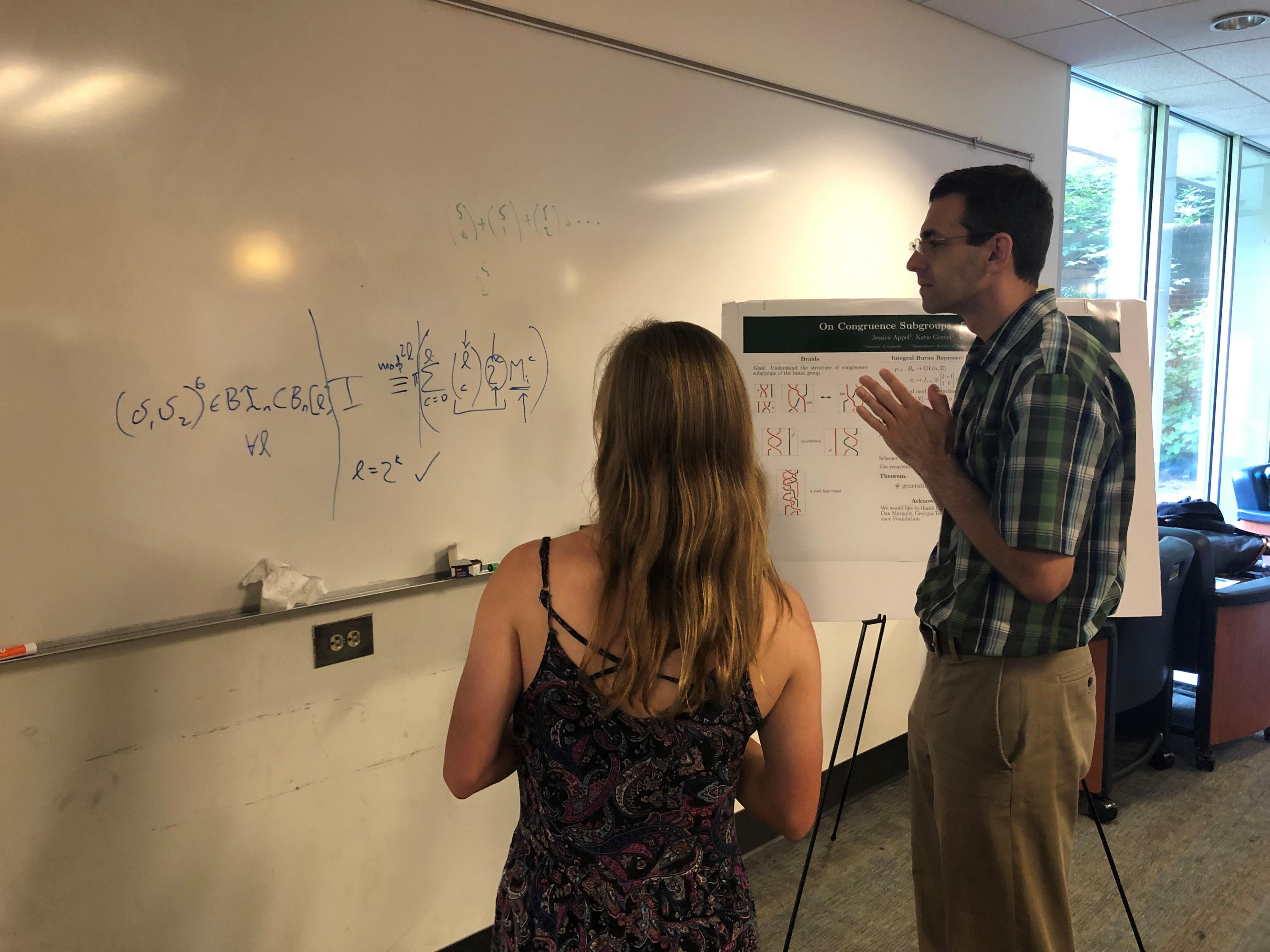 School of Math Professor Dan Margalit listens to a Summer REU 2019 presentation (Photo by Yasmine Bassil)