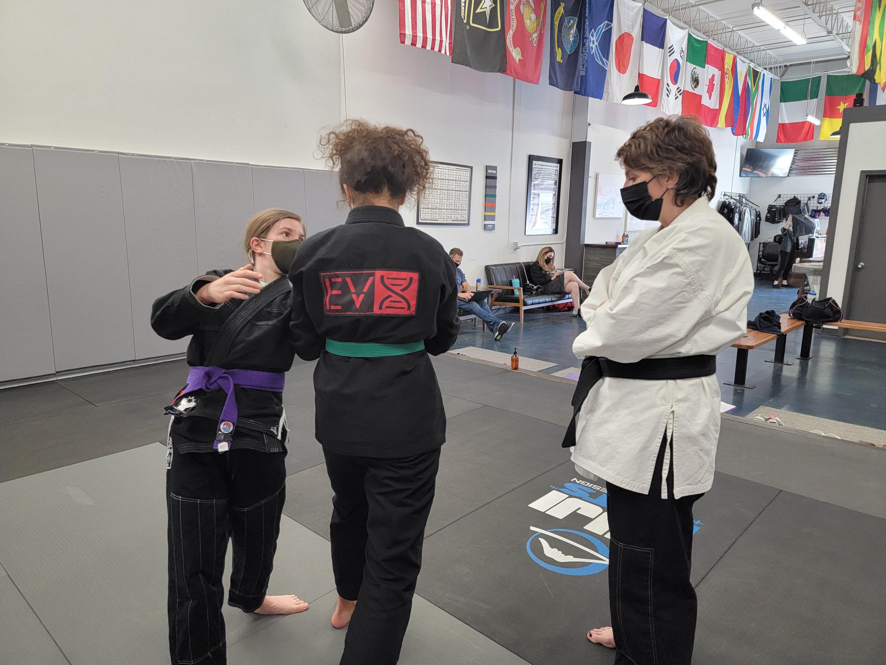 Pamela Pollet watches students practice throws at Evolution X Martial Arts (Credit: Evolution X)