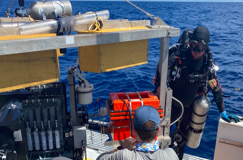 Divers preparing the autonomous benthic lander vehicle developed by Georgia Tech's Martial Taillefert during exploration of the Gulf of Mexico's 