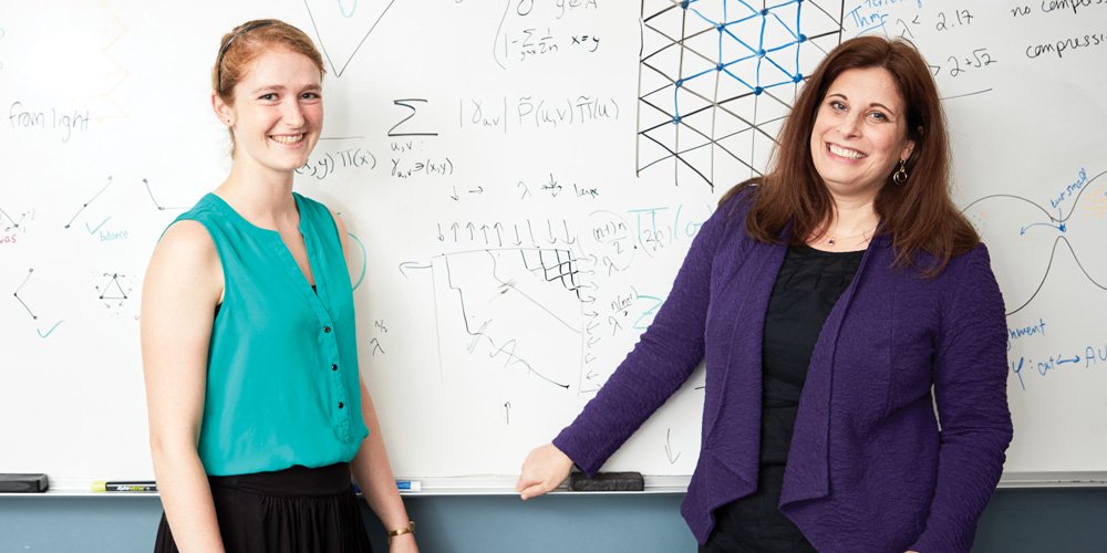 Sarah Cannon, Georgia Tech alumna and assistant professor in the Mathematics Department of Mathematical Sciences at Claremont McKenna College, with Dana Randall (Credit: Georgia Tech)
