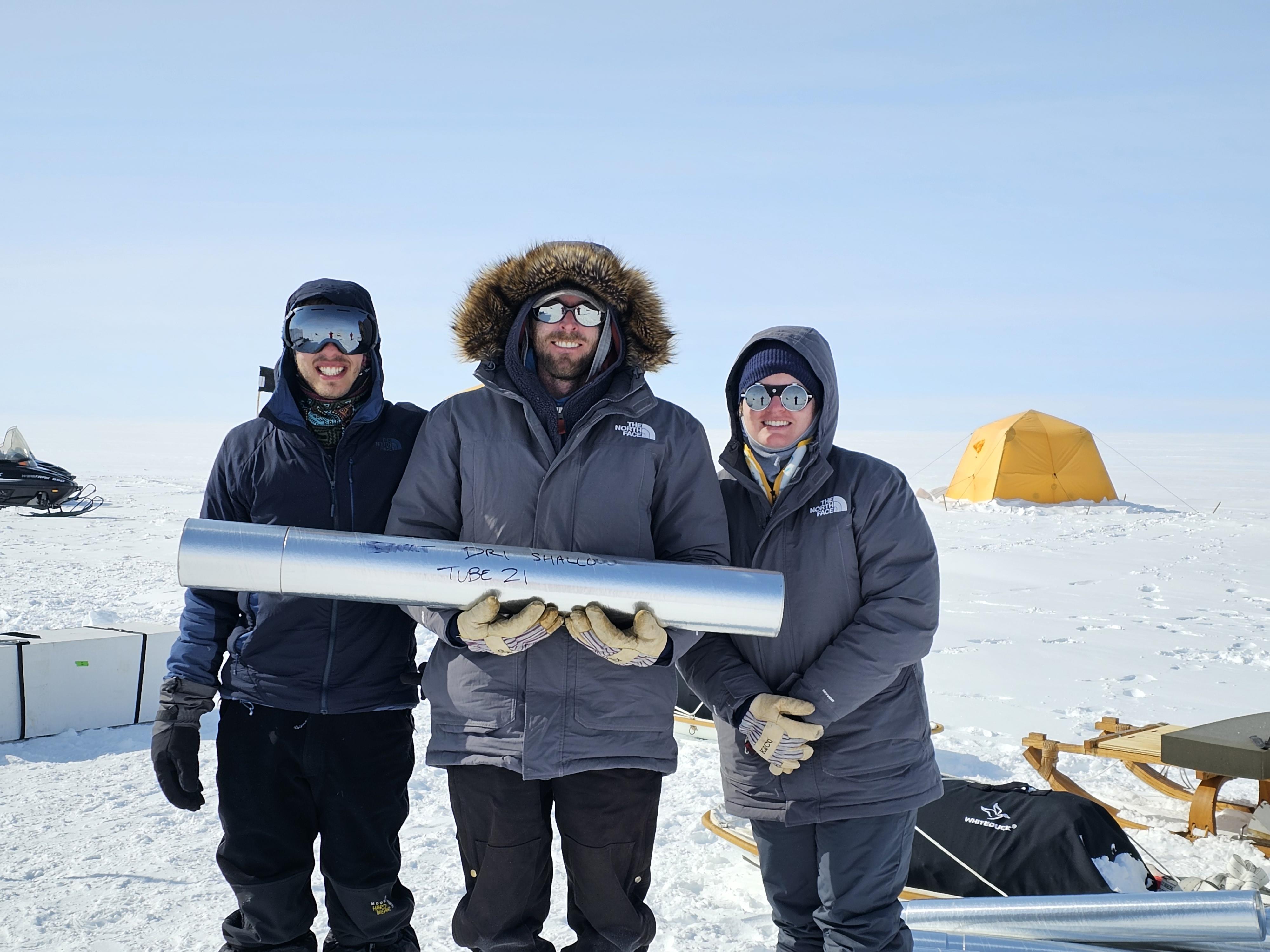 Left to right, PhD student Benjamin Riddell-Young, Nathan Chellman, and Rachel Moore holding an ice core at a remote field site.