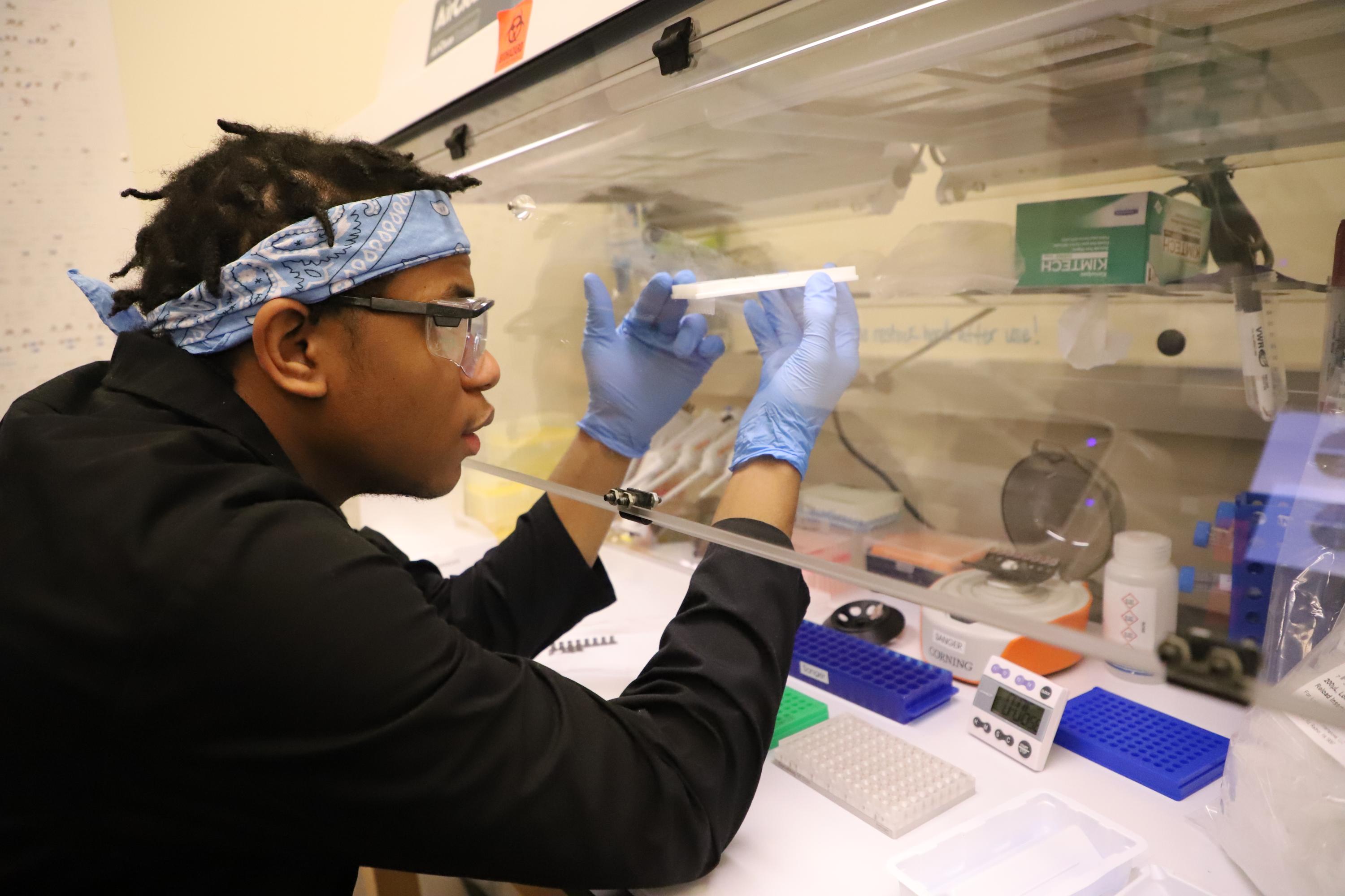 First-year chemical engineering student Aaron Kent examines a sample.