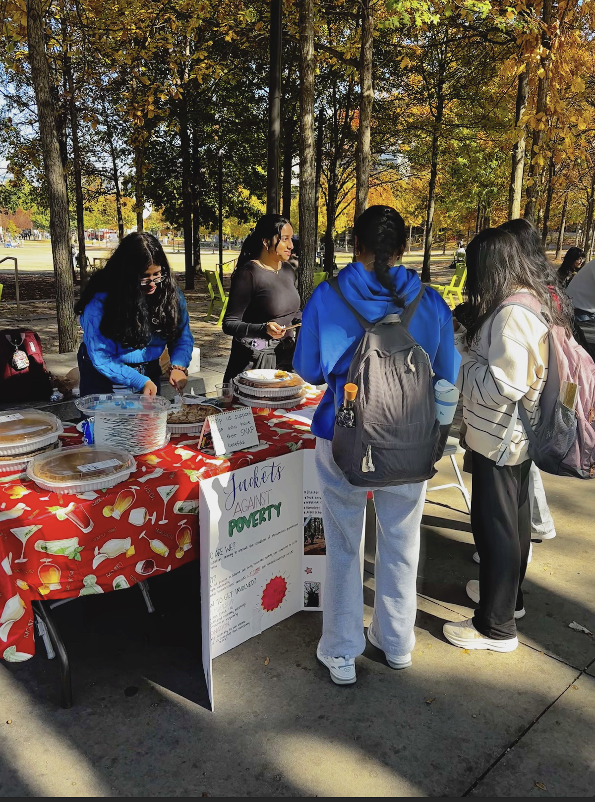 Yellow Jackets Against Poverty Social Chair Navitha Manivannan and Finance Chair Ankita Rajiv sell pies to finance a clothing drive.
