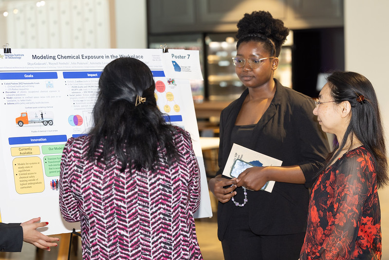 Students answer questions about their poster