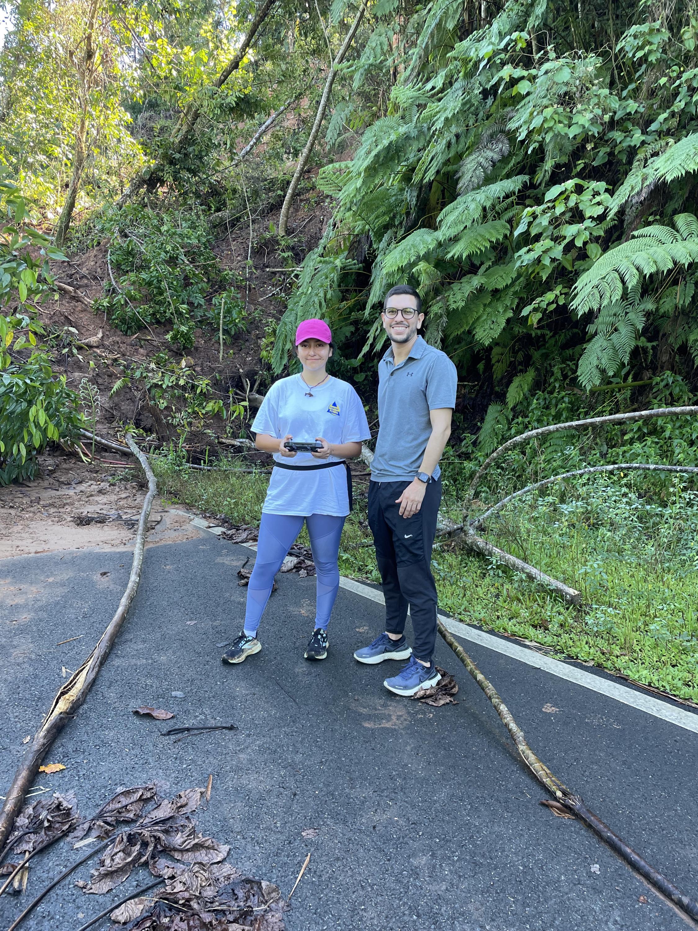 From October '22 Puerto Rico trip: CEE graduate students Paola Vargas-Vargas (left) and Jorge Lozano Ramirez fly a drone to take pictures of a landslide. (Photo Frances Rivera-Hernández) 