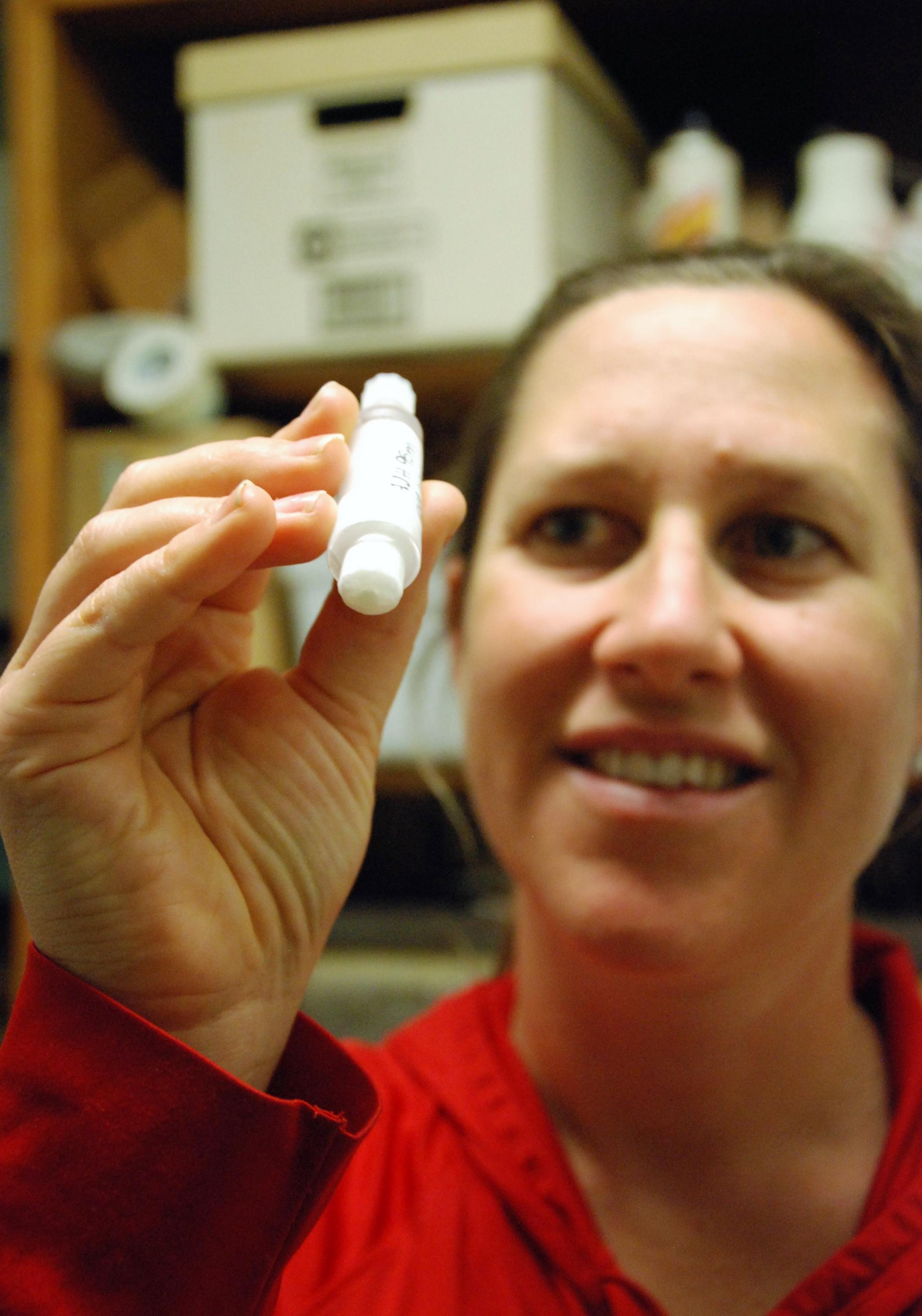 Nastassia Patin, postdoctoral researcher in the School of Biological Sciences, holds a water sample taken during her study of blue holes off Florida's western coast. 