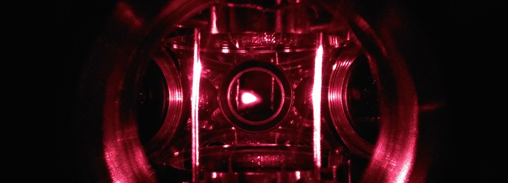 A closeup of the magnetic optical trap (MOT) in Colin Parker's quantum simulator. The glowing spot in the image center is the fluorescence from about 1 billion atoms cooled to less than a 1/1000 of a degree above absolute zero. (Photo Colin Parker)