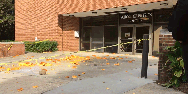Two pumpkins fall from atop the Howey Physics Building.