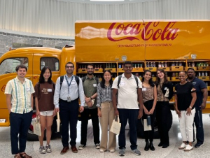 Georgia Tech alumni led behind-the-scenes tours at Coca-Cola’s Atlanta headquarters. As part of their tour, students checked out an original 1949 yellow delivery truck parked in the rotunda of Coke’s Central Reception Building.