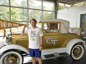 Josh Hembree, a mathematics major from Villa Rica, Georgia, poses with the Ramblin’ Wreck, Georgia Tech’s 1930 Ford Model A Sport Coupe mascot, of which he is the sole driver for 2025. 