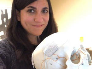 Students are often involved in Ragan's outreach efforts. Here, Ragan is holding a student-designed electroconvulsive-therapy model for a Brain Awareness Day event.