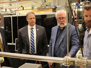 (From left) Georgia Congressman Tom Graves, NASA Administrator Jim Bridenstine, School of Chemistry and Biochemistry Professor Thom Orlando, and postdoctoral researcher Zach Seibers in the REVEALS lab. (Photo by Renay San Miguel)