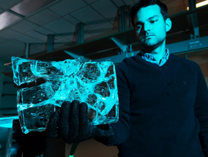 Alexander Robel holds ice used in glacial melt research. 