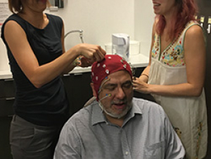 Audrey Duarte and Brittany Corbett adjust memory test sensors on ScienceMatters host Renay San Miguel