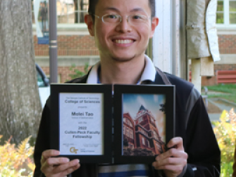 Molei Tao holding his College of Sciences Faculty Development Award during the 2022 Spring Sciences Celebration.