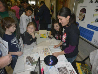 Christina Ragan challenging attendees with optical illusions at a previous Brain Awareness Day Neuroscience event held at Michigan State University.