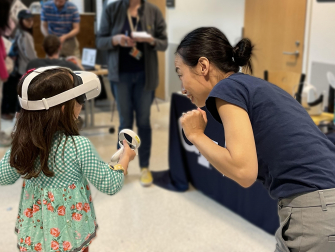 A young participant experiencing virtual reality for the first time at the 2023 Georgia Tech Science and Engineering Day.