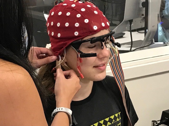 Study participant Olivia Cox is prepared for eye-tracking research (Photo by Renay San Miguel.)